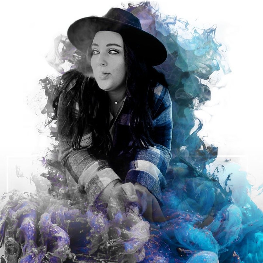 Rebekkah Burket in a black wide-brim hat exhaling smoke, with blue and purple smoke art